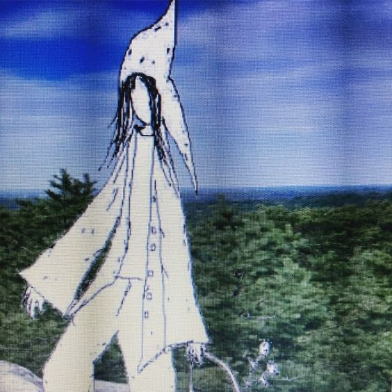 Ghostly figure above a forest